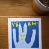 an art print of a snow hare is on a desk